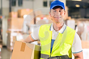 Worker holds package in warehouse of forwarding