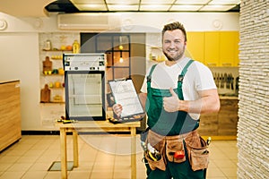 Worker holds repair checklist against refrigerator