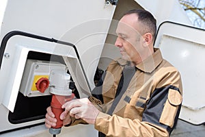 worker hooking up power supply