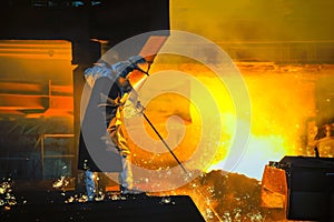 worker with hot steel in the steel plant