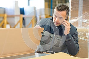 Worker inspecting packaging container
