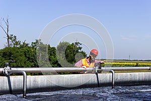 Worker inspecting valve during filtration