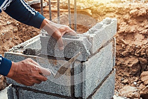 worker installing bricks in construction