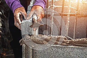 worker installing bricks in construction