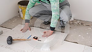 Worker installing the ceramic wood effect tiles on the floor