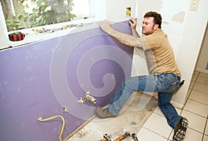 Worker Installing Drywall