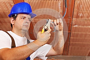 Worker installing electrical wiring