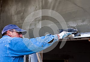 Worker installing external insulation Facade therm