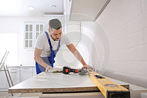 Worker installing new countertop in kitchen