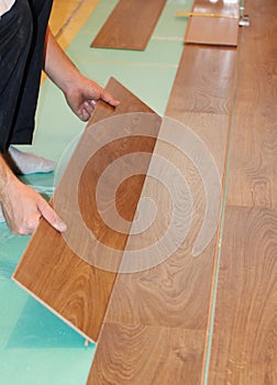 Worker installing new laminate flooring