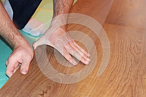 Worker installing new laminate flooring