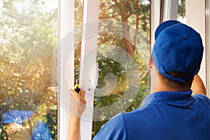 Worker installing new plastic pvc window