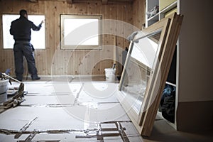 Worker installing new wooden windows