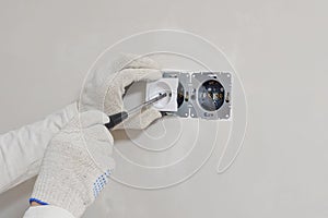 Worker installing the power outlet, close up