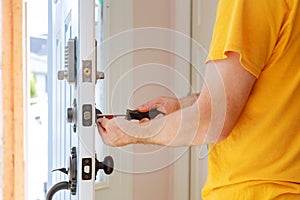 Worker installing or repairing new lock