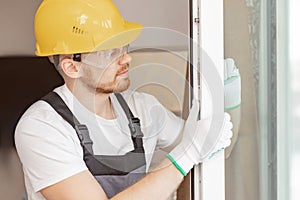 Worker in installing rubber seals on plastic upvc window