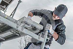 Worker Installing Scaffolding photo