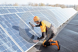 Worker installing solar panels