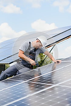 Worker installing solar panels outdoors