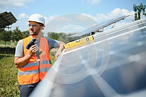 Worker installing solar panels outdoors