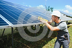 Worker installing solar panels outdoors