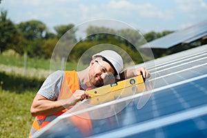 Worker installing solar panels outdoors