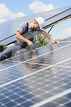 Worker installing solar panels outdoors