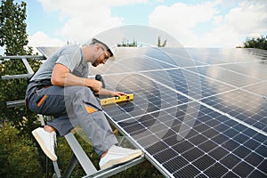 Worker installing solar panels outdoors