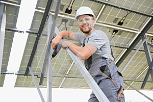 Worker installing solar panels outdoors