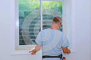 Worker installing trim around a window