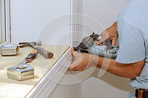 Worker installing trim around a window