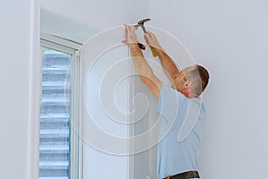 Worker installing trim around a window