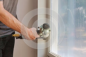 Worker installing trim around a window