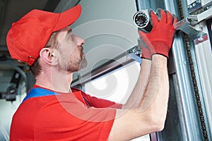 Worker installing video surveillance camera