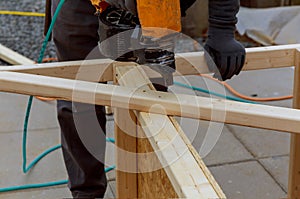 Worker installing wood floor for hammering on a deck patio