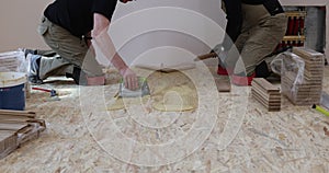 Worker installing wood parquet.Construction in a renovated room installation of parquet