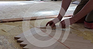 Worker installing wood parquet.Construction in a renovated room installation of parquet