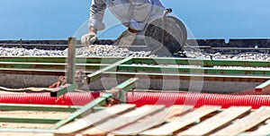 A worker installs formwork at a construction site