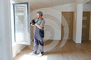 A worker installs windows in a new modular home. The concept of a new home.
