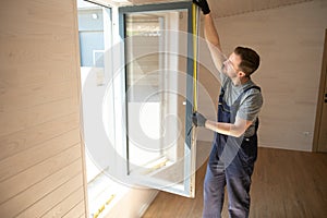 A worker installs windows in a new modular home. The concept of a new home.