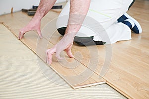 Worker joining parquet floor.