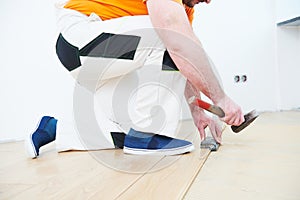 Worker joining wooden parquet floor