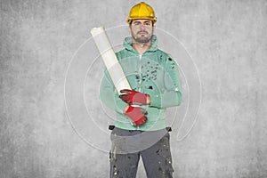The worker keeps building plans on his shoulder