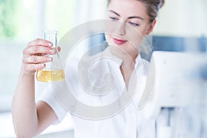 Worker of laboratory holding flask