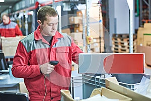 worker with laser barcode scanner at warehouse