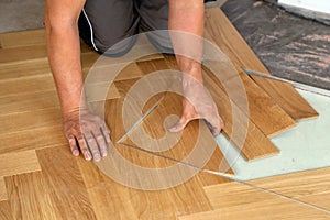 Worker laying parquet flooring