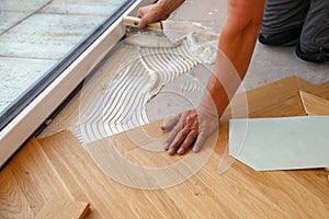 Worker laying parquet flooring