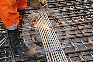 Worker legs weld metal grating