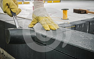 Worker Levelling Patio Concrete Floor Bricks Close Up