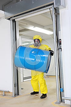 Worker lifting barrel of toxic substance photo
